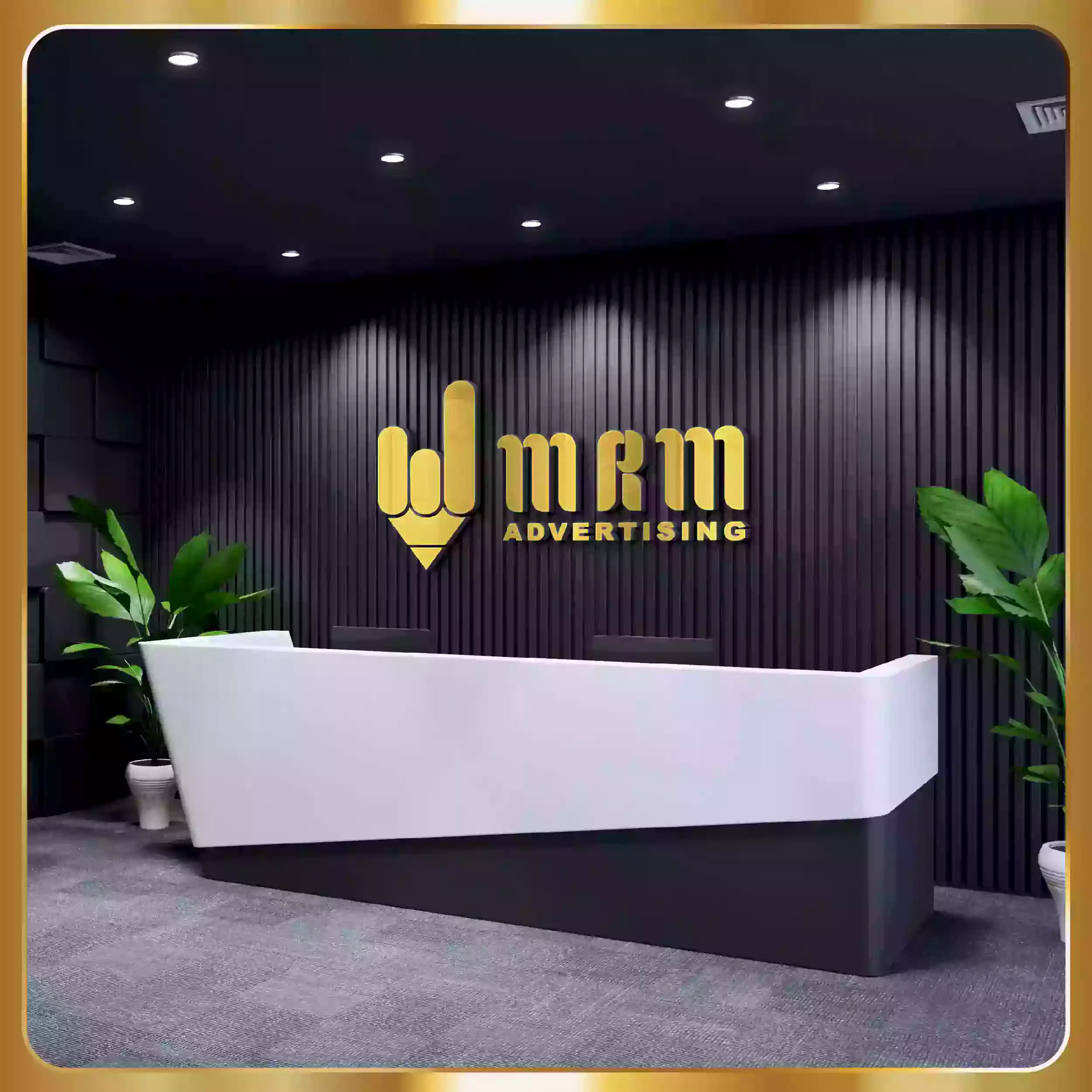 The logo for design advertising is on a desk in a room.